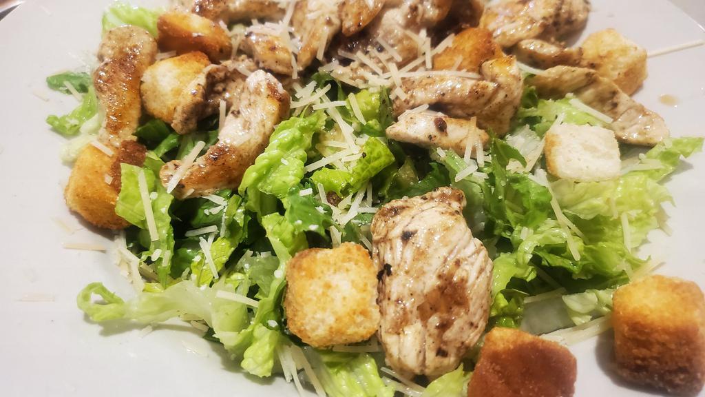 Chicken Caesar Salad · Grilled chicken breast served on a bed of romaine lettuce with parmesan cheese & croutons