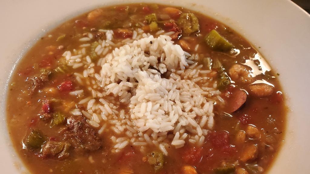 Shrimp & Sausage Gumbo · Shrimp, andouille sausage, onion, celery, tomato in a spicy roux served with white rice