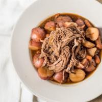 Pot Roast · Slow-cooked tender beef served with potatoes and carrots in a delicious beef broth.
