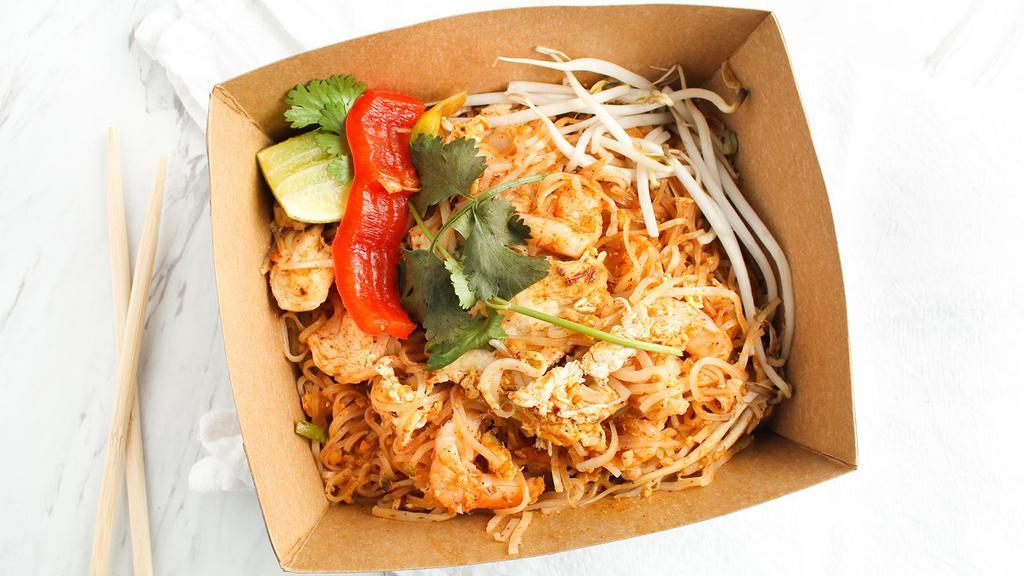 Pad Thai (Chicken & Shrimp) · GLUTEN FREE UPON REQUEST. The national dish of Thailand. Rice noodles stir fried with chicken, shrimp, eggs, bean sprouts, scallions, peanuts and pad Thai sauce. Garnished with fresh bean sprouts and a wedge of lime.