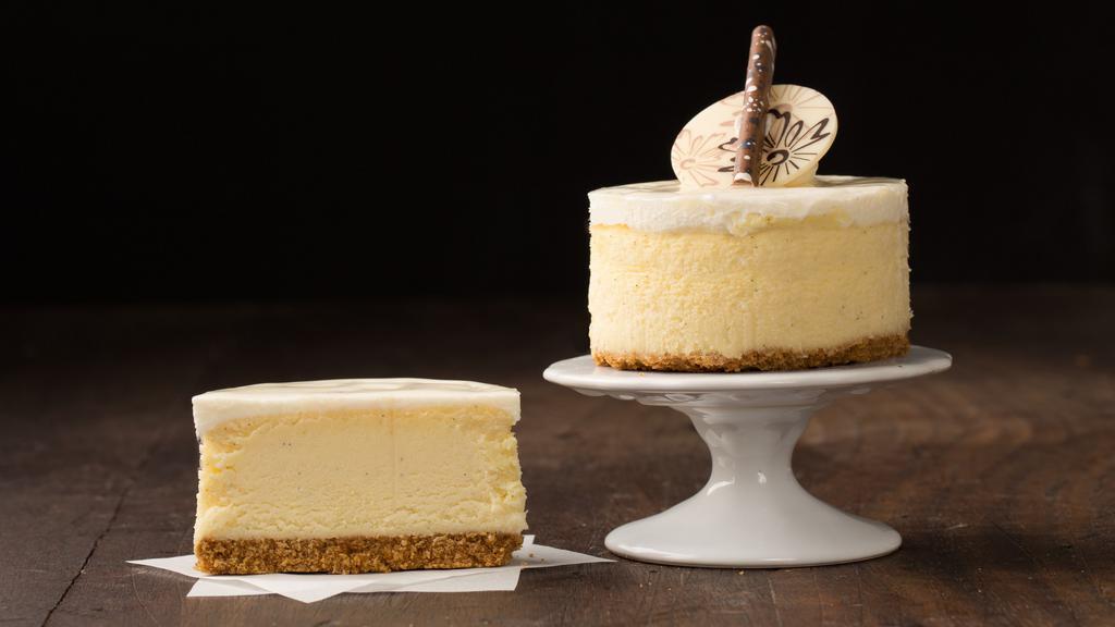Mini Vanilla Bean Cheesecake · Cheesecake flavored with real Madagascar vanilla beans.  The cheesecake sits on top of a graham cracker crust and is iced with a cream cheese icing.  Finished with chocolate decorations.

Contains: Wheat, Soy, Milk, Egg