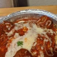Meat Ravioli · Ravioli stuffed with beef, spinach, romano and parmesan cheese and smothered in homemade pas...