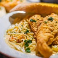 Cajun Crawfish Pasta · Louisiana crawfish & linguini pasta in a Cajun sauce topped with two pieces of fried Louisia...
