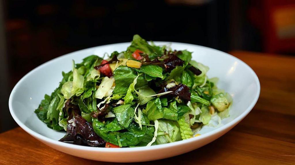 Farm Stand Salad · Mixed greens, shaved green cabbage, avocado, smoked corn, roma tomatoes, carrots, pickled red onions, roasted shallots vinaigrette.