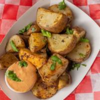 Tators · Fresh cut potatoes griddled fried and seasoned.
