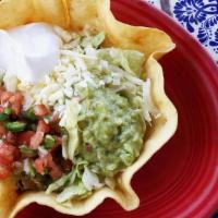 Lunch Taco Salad Fajita · Crispy taco bowl shell filled with your choice of chicken fajita or steak fajita, topped wit...