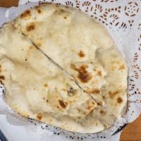 Naan · Traditional soft white bread.