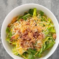 Cajun Crunch · Crisp romaine lettuce, bacon, cheddar jack cheese, toasted pecans and all-natural cajun chic...