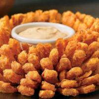 Bloomin' Onion® · An Outback Original! Our special onion is hand-carved, cooked until golden and ready to dip ...
