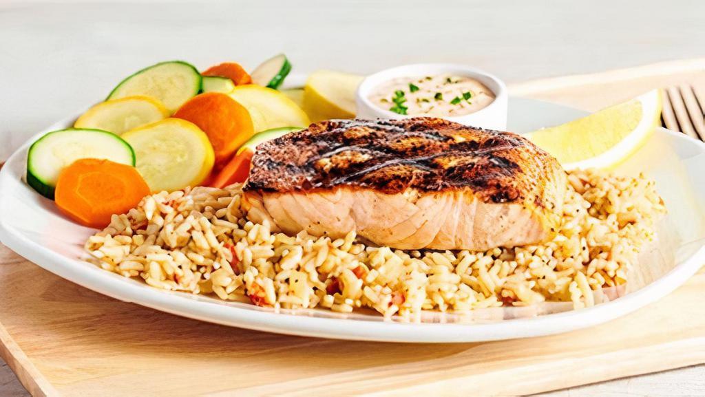 Perfectly Grilled Salmon · Seasoned and grilled. Served with our classic rémoulade sauce. Served with two freshly made sides.