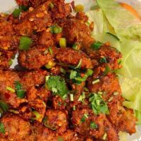 Chicken 65 · Spiced chicken sautéed with southern Indian spice mix, yogurt and curry leaves