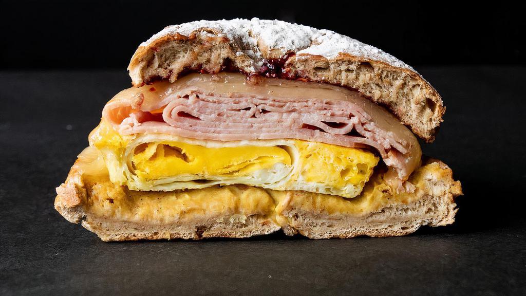 Fancy Ham, Egg & Cheese Sandwiches · Toasted French toast bagel with country ham, Munster cheese, baked over hard egg, dijon mustard, and raspberry jam. 790 calories.