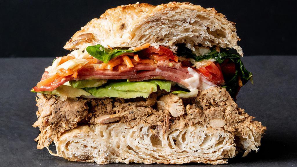 The Real Chicken Sandwich · Toasted multi-grain croissant with char roasted chicken, avocado, mayo, tomato, and TCCP greens.