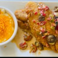 Catfish & Grits · Fresh catfish fried to perfection over a bowl of creamy smoked Gouda grits topped with a cra...