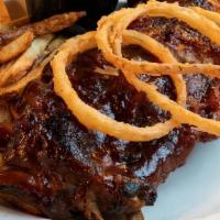Slow Roasted Baby Back Ribs · Served with Tavern  fries, house-made coleslaw and onion strings.