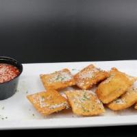 Toasted Ravioli* · Italian Cheese Filled Ravioli, lightly breaded. Served with Classic Red Sauce