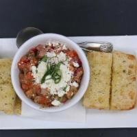 Bruschetta · Fresh Roma Tomatoes, Red Onions, tossed with Pesto Vinaigrette and topped with Feta Cheese a...