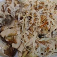 Pollo Con Tajadas · Fried chicken, green banana slices, cabbage salad, and red and white sauce.

Pollo frito con...
