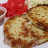 Pupusas De Frijol Con Queso · 3 pupusas made of corn dough, stuffed  beans & cheese.  Accompanied by a cabbage salad and p...
