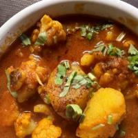 Aloo Gobhi · Cauliflower and potatoes cooked with herbs and mild spices. White basmati rice included.