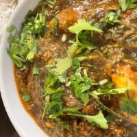 Goat Saag · Bone-in goat cooked with fresh spinach and flavored with fresh spices. White basmati rice in...