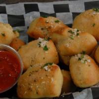 Garlic Bites · Homemade puffy bites of dough smothered in our homemade garlic butter & grated parmesan. Ser...