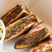 Arayes · Lebanese beef stuffed pitas served with tzatziki for dipping and choice of side (think of th...