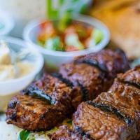 Grilled Steak Kabobs · Marinated in honey and Aleppo pepper with Turkish spices.  Served with Jasmine rice, pita, a...