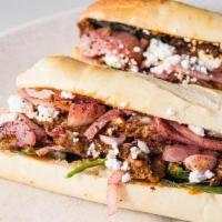 Moroccan Lamb Baguette · Fresh spinach, sumac onions, feta cheese and hand pulled lamb served on a crispy baguette.  ...