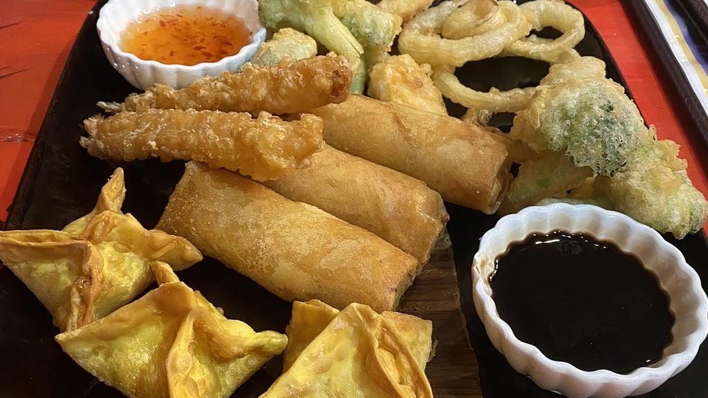 A-7. Combo Platter (Good Choice) · Combination of (4) spring rolls, (2) crab rangoon, (2) shrimp tempura, (6) vegetable tempura and (2) served with pineapple sauce and dipping sauce.
