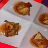 Shrimp Wontons · Shrimp and cream cheese stuffed wonton pouches served crispy and topped with a shrimp and ga...