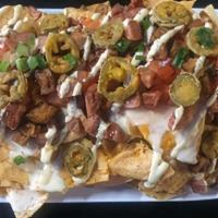 Swamp Nachos · Tortilla chips topped with alligator sausage, Patton's hot sausage, queso, shredded cheddar,...