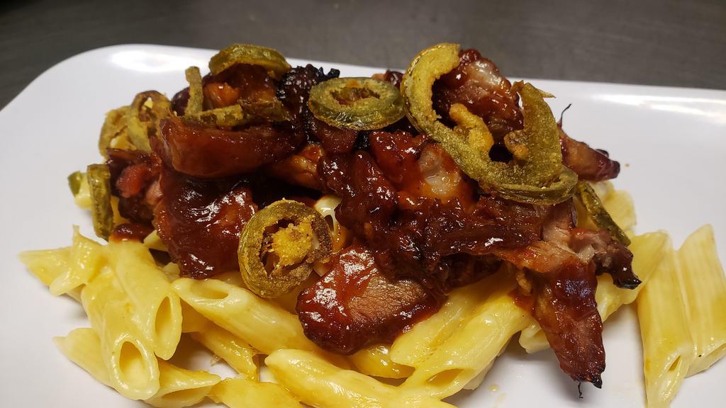 Bbq Pork Mac And Cheese · Baked mac and cheese topped with slow roast BBQ pulled pork and fried jalapeños.