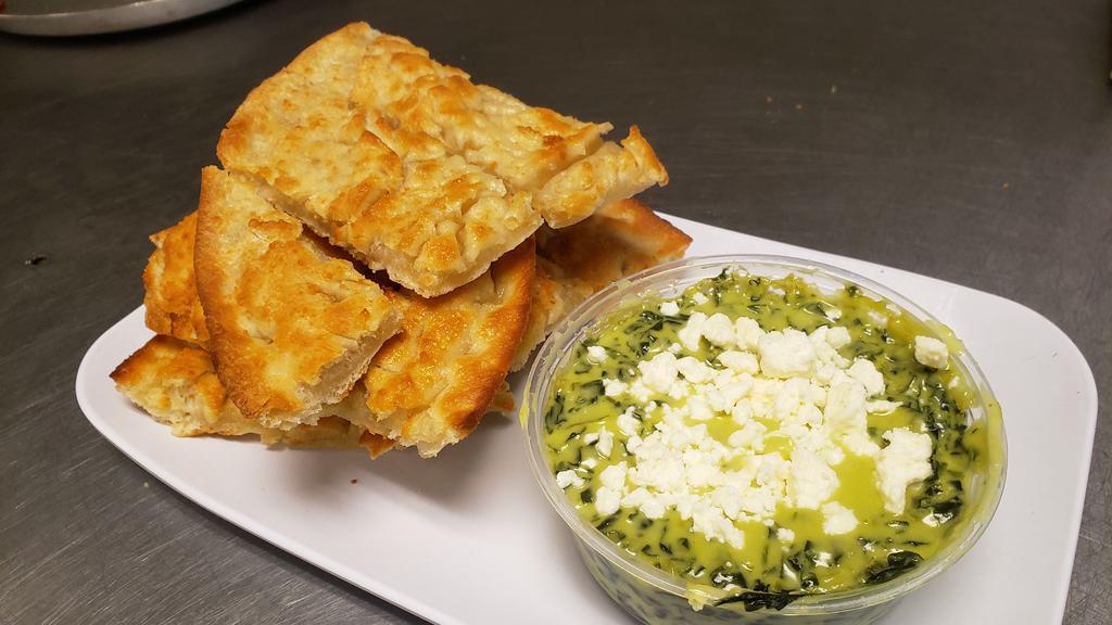 Spinach And Artichoke Dip · Topped with feta cheese and served with bread sticks.