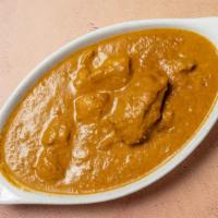 Chicken Korma · Chicken cooked with yogurt, cashew nut sauce and garnished with almonds.