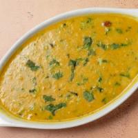 Yellow Daal · Yellow lentils tempered and seasoned with cilantro, garlic, ginger and mild spices.