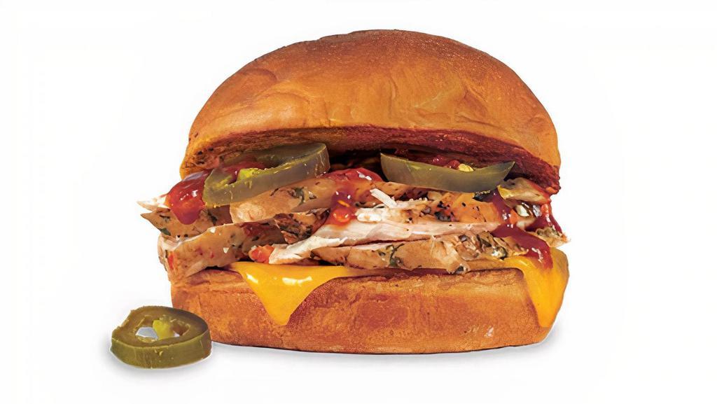 Kings Hawaiian Spicy Chicken & Cheddar Sandwich. · Pit-Smoked Marinated Chicken Breast with Cheddar Cheese, Signature Spicy Barbecue Sauce & Jalapeños, on a Sweet King's Hawaiian® Bun