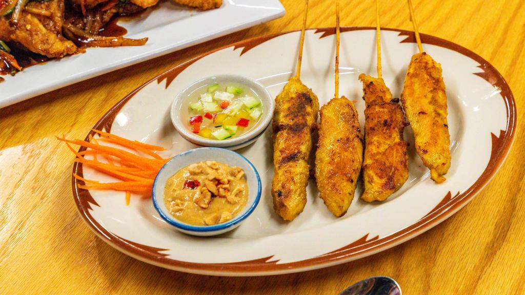 Satay(4) · Three pieces. Grilled chicken marinated in coconut milk and curry spices. Served with peanut sauce.