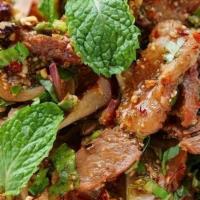 Thai Beef Salad · Sliced beef, onions, pepper, cilantro, cabbage with rice.