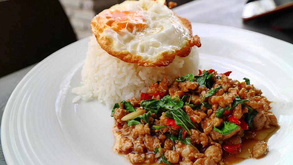 Pad Kha Pow · Sauteed meat with Thai sauce, bell pepper, onion, carrot, snow peas, and basil. Served with rice.
