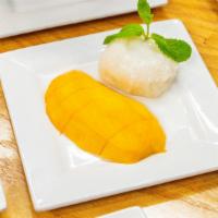 Sticky Rice With Mango · Mango in sweet sticky rice topped with sweet coconut milk.