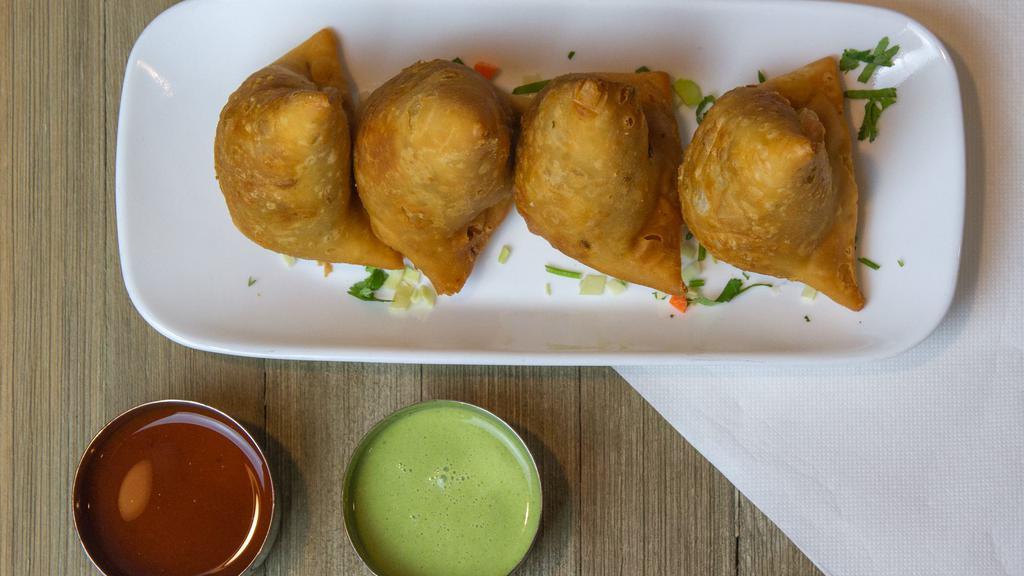 Samosas · Fried pastry with a savory filling of spiced potatoes and green peas. A pocket bursting with flavor.