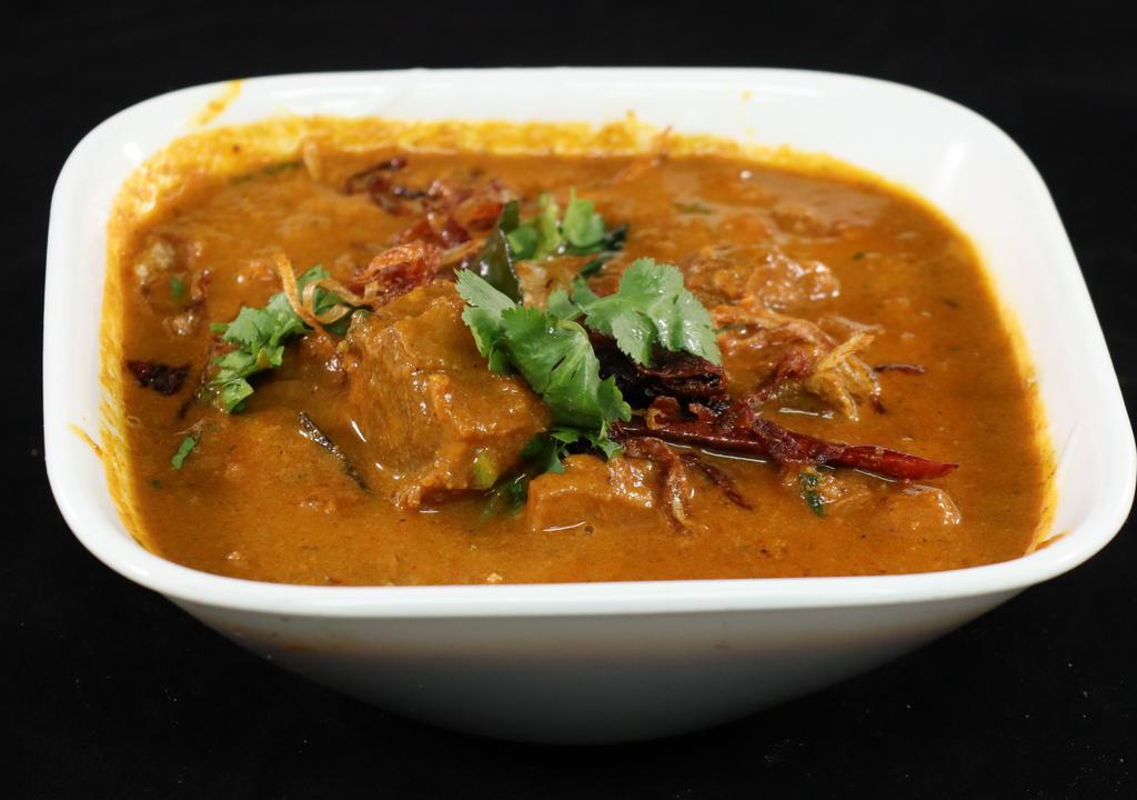 Goat Curry · Goat cooked with onions, tomatoes, ginger, garlic and special spices.
