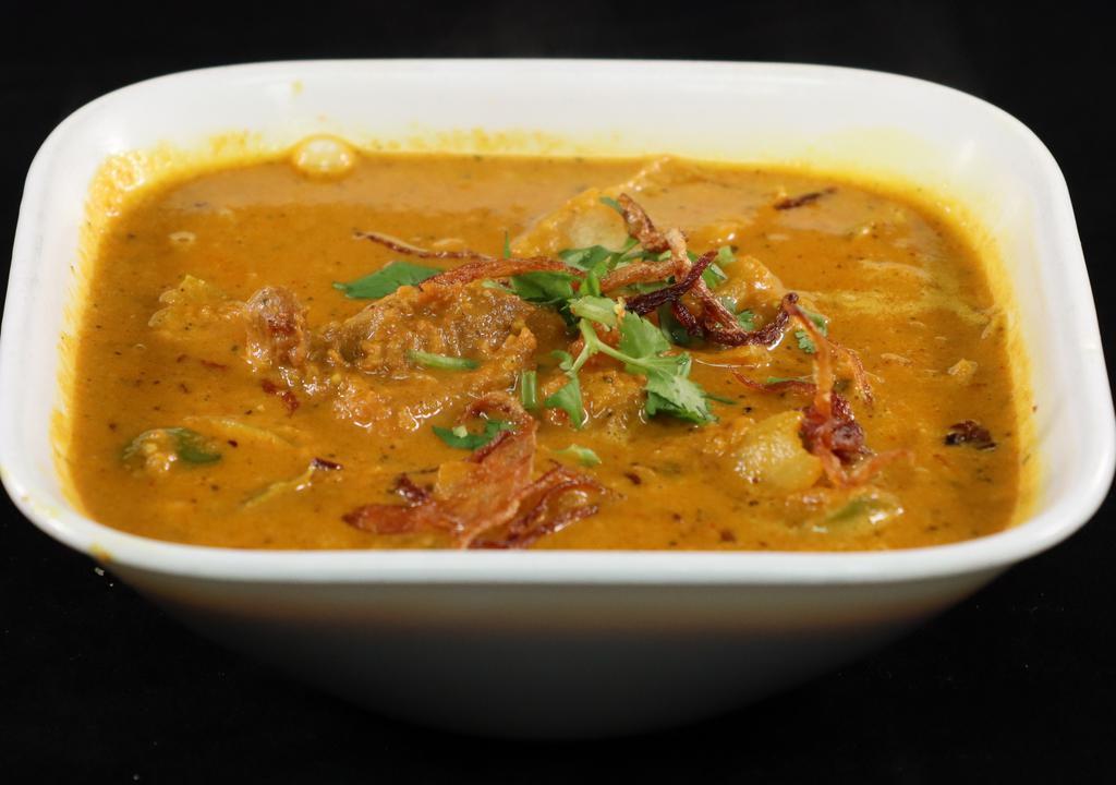 Goat Kadai · Goat cooked in a tomato and onion gravy base. This dish only requires one kadai (utensil) to get cooked.