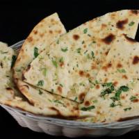 Garlic Naan · Leavened homemade bread baked in a clay oven with garlic, cilantro and butter.