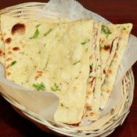Butter Naan · Leavened homemade bread baked in a clay oven with butter.