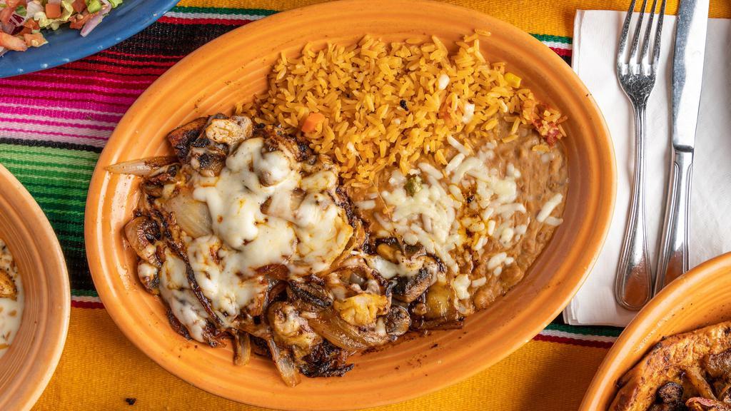 Pollo Monterrey · Grilled chicken breast with onions, mushrooms, and Monterey Jack cheese. Served with rice, beans, and your choice of corn or flour tortillas.