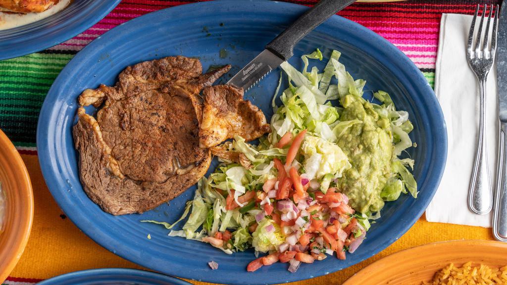 Carne Azada · Thin choice ribeye steak with rice and beans. Served with guacamole salad and pico de gallo, corn or flour tortillas.