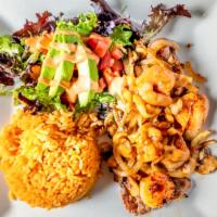 Steak Vallarta · Grilled steak and shrimp cooked with onions, mushrooms, and chipotle sauce, served with two ...