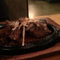 Korean Bbq Ribs · 14-ounce marinated short ribs with enoki mushrooms and onions, served with sizzling Korean B...